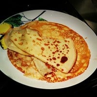 Plate full of savoury crepes made of refined wheat flour