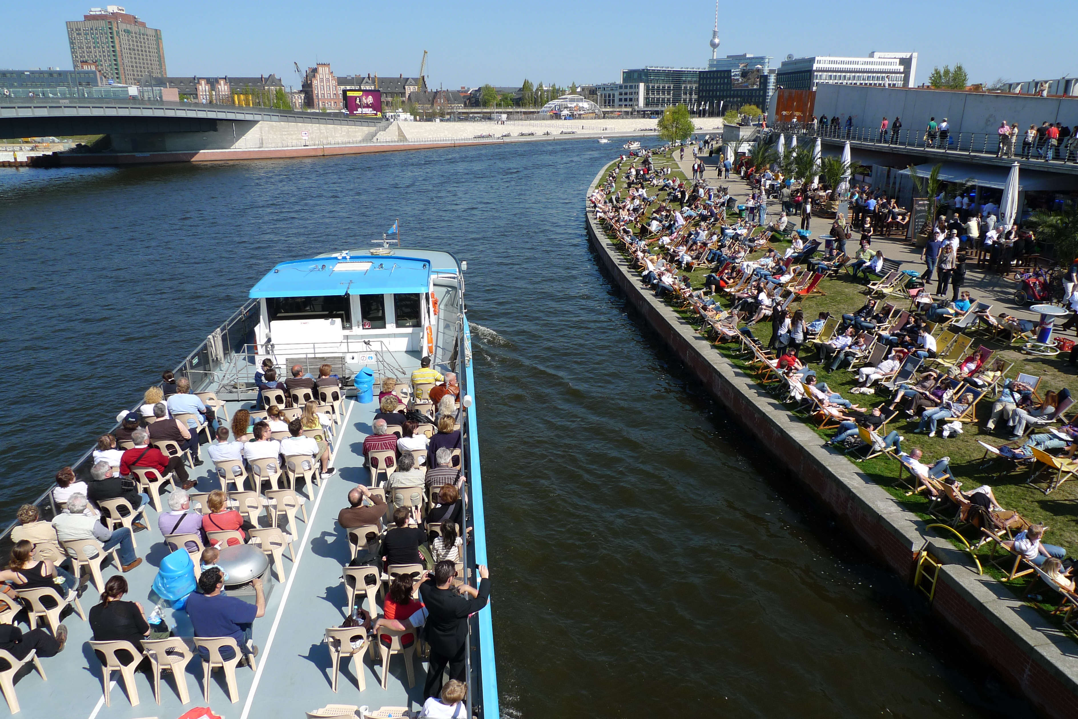 When the tour boats rife with rooftop tourists on white plastic chairs glide along the Spree, when the pale-flanked Europeans in tank tops quaff beer on makeshift bar beaches, when the sky is blue and not low clouds of steel gray, when the Fernsehturm glints and glimmers in a bright spiritual cross, then it is surely approaching tourist season in Berlin, Germany.