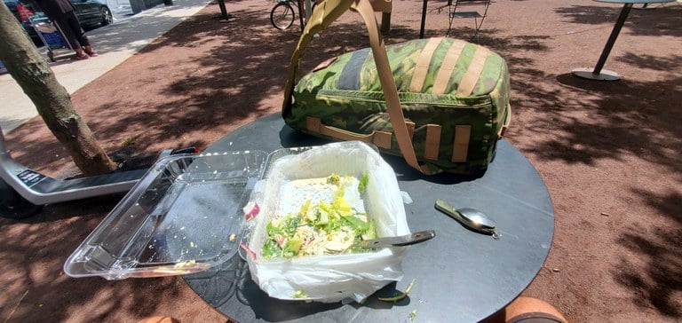 My day-one, mostly-completed, big-ass salad sitting next to my tropical multicam GoRuck Rucker 4 backpack. 
